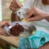 Tasting fresh Dominican cacao Freshly ground cacao offered on a metal plate by one of the women of the house