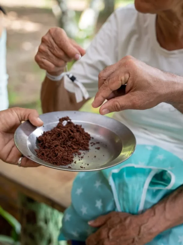 Tasting fresh Dominican cacao Freshly ground cacao offered on a metal plate by one of the women of the house