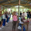 The tasting under the shelter The tour group raising cups together at a countryside tasting under a tin-roofed shelter