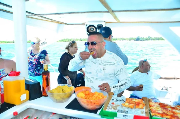 Guests help themselves to bowls of fresh pineapple and papaya at the on-board buffet counter