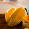 Golden cacao pods on a wooden board at the organic products tasting stop