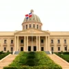 The domed National Palace behind terraced steps and flowering gardens with the Dominican flag flying